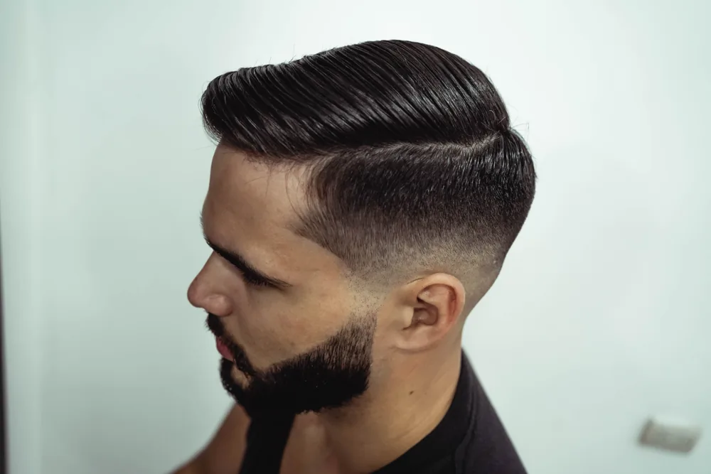 Side profile showing a styled haircut and defined beard; stock inspiration photograph